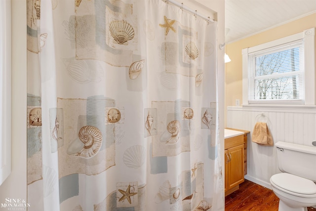 bathroom featuring vanity, crown molding, toilet, walk in shower, and wood-type flooring