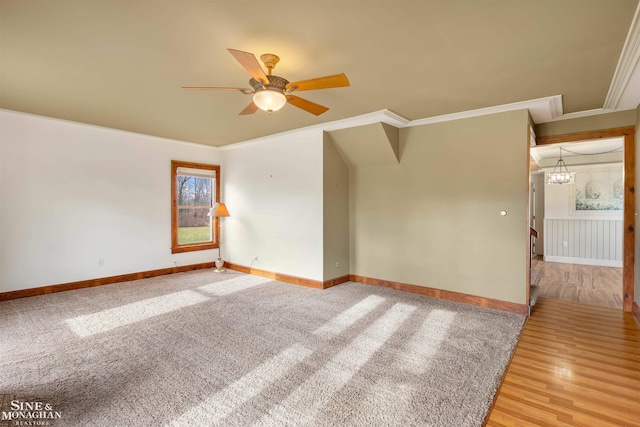 unfurnished room featuring wood-type flooring, ceiling fan with notable chandelier, and ornamental molding