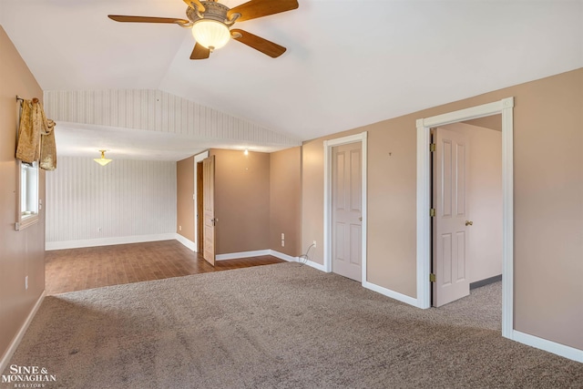 empty room with carpet flooring, ceiling fan, and lofted ceiling