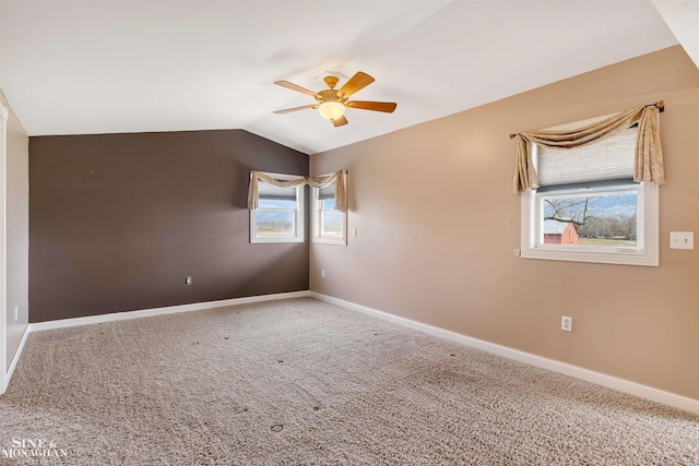 unfurnished room with carpet flooring, vaulted ceiling, and ceiling fan