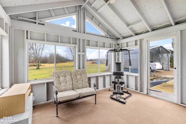 sunroom with vaulted ceiling with beams and a healthy amount of sunlight