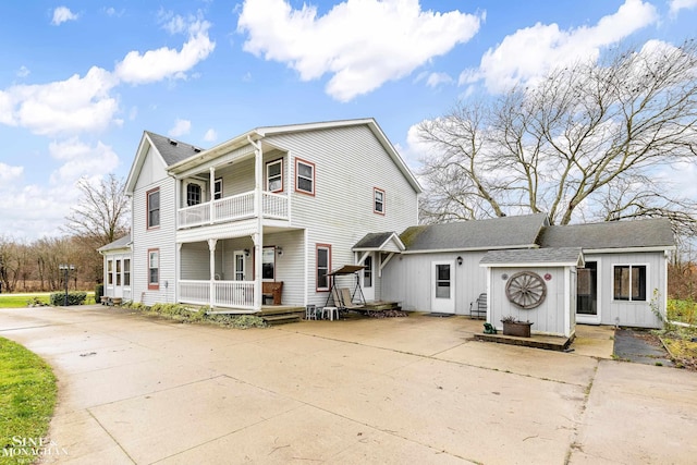 view of front of house featuring a porch and a balcony