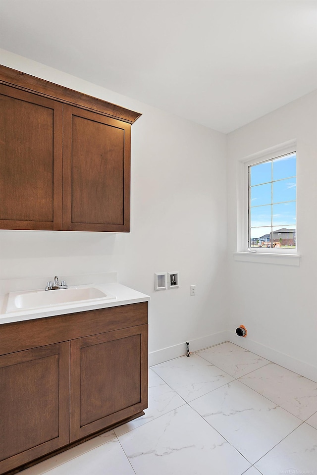 laundry room featuring washer hookup, cabinets, and sink