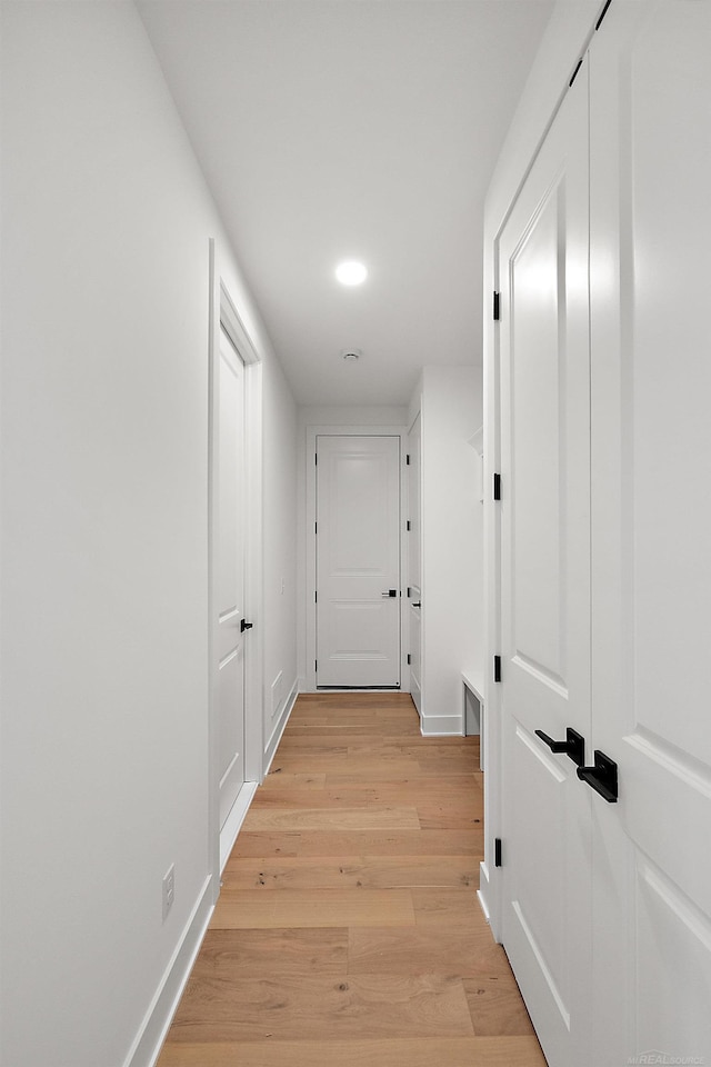 corridor with light hardwood / wood-style flooring