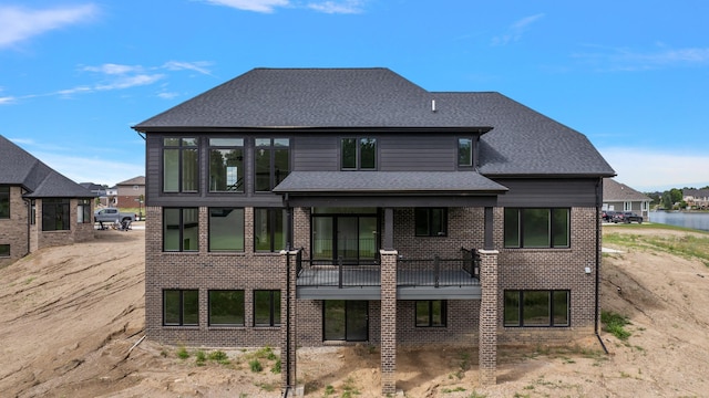 rear view of property with a water view