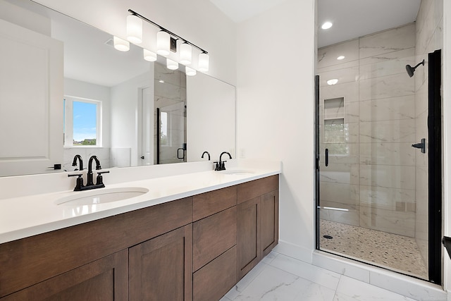 bathroom featuring an enclosed shower and vanity