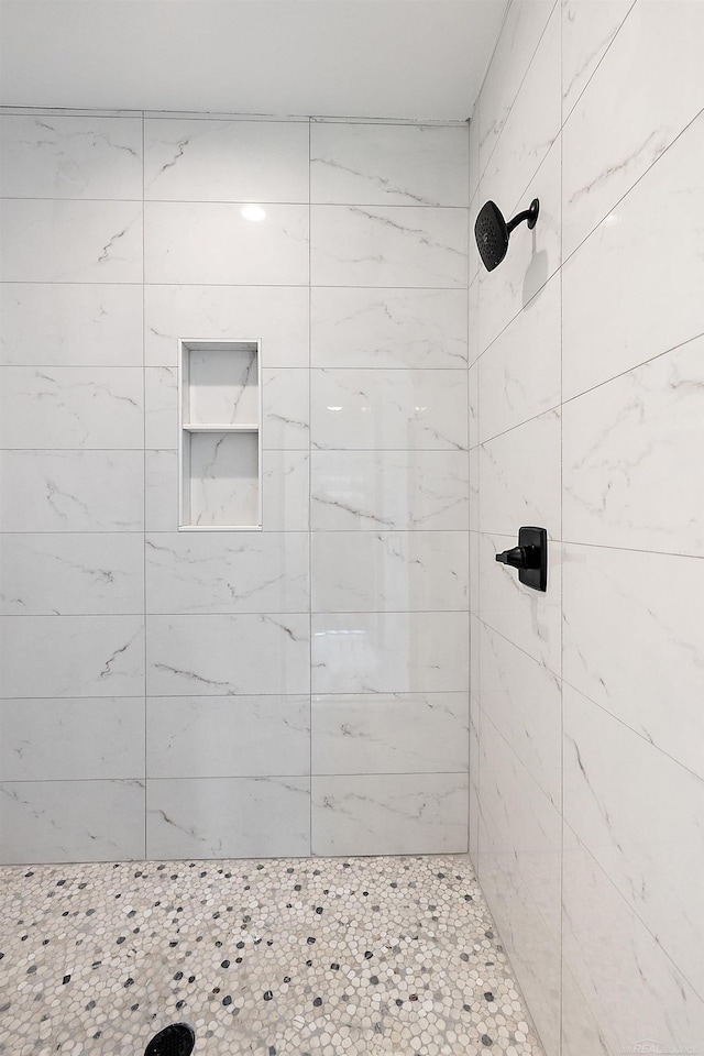 bathroom with a tile shower