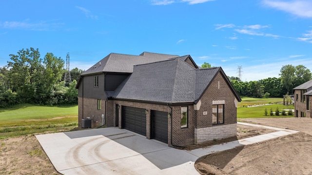 view of home's exterior featuring cooling unit, a yard, and a garage