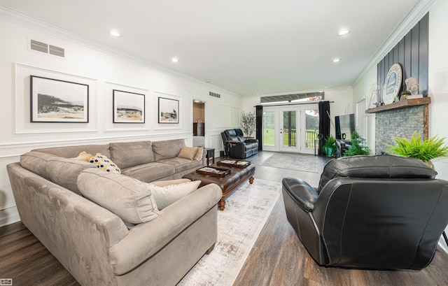 living room featuring a fireplace, french doors, dark hardwood / wood-style flooring, and ornamental molding