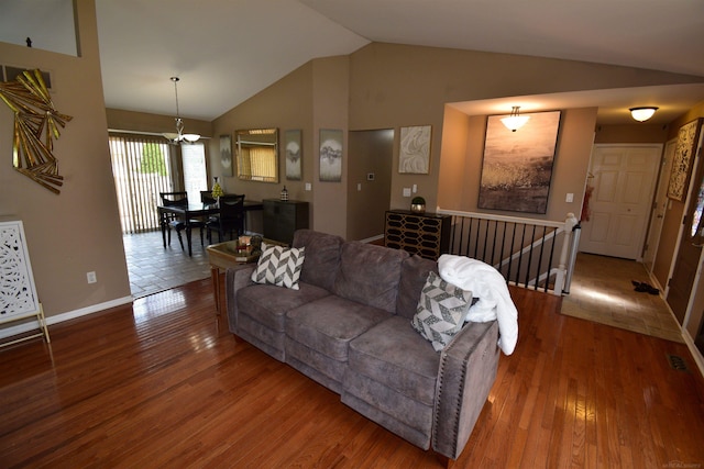 living room with hardwood / wood-style floors and vaulted ceiling