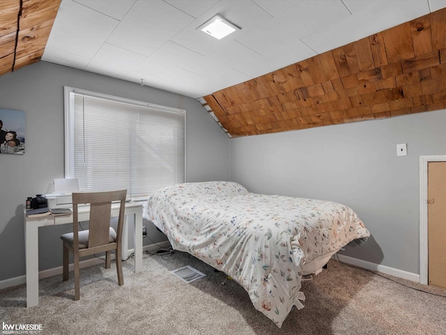 carpeted bedroom with lofted ceiling