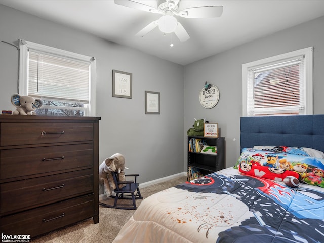 carpeted bedroom with multiple windows and ceiling fan