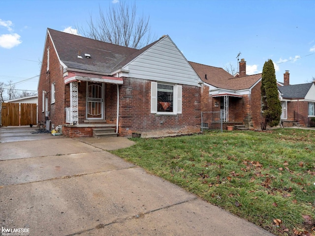 bungalow-style home featuring a front yard