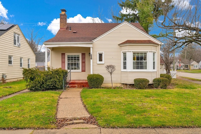 bungalow-style home with a front lawn