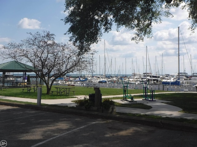 view of home's community featuring a gazebo, a water view, and a yard