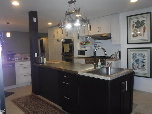 kitchen featuring white appliances, sink, pendant lighting, white cabinets, and an island with sink