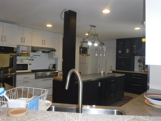 kitchen featuring pendant lighting, stainless steel appliances, white cabinetry, and sink