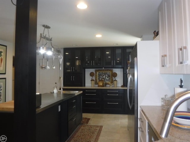 kitchen featuring decorative light fixtures, light tile patterned flooring, and sink