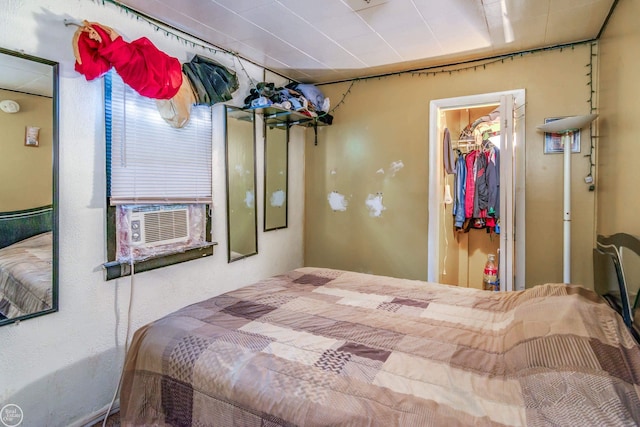 bedroom with a spacious closet, a closet, and cooling unit