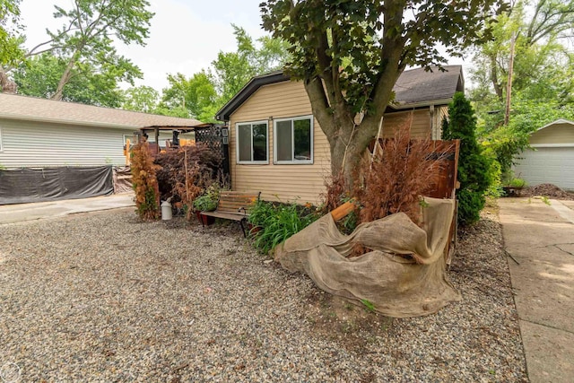 view of home's exterior featuring an outdoor structure and a garage