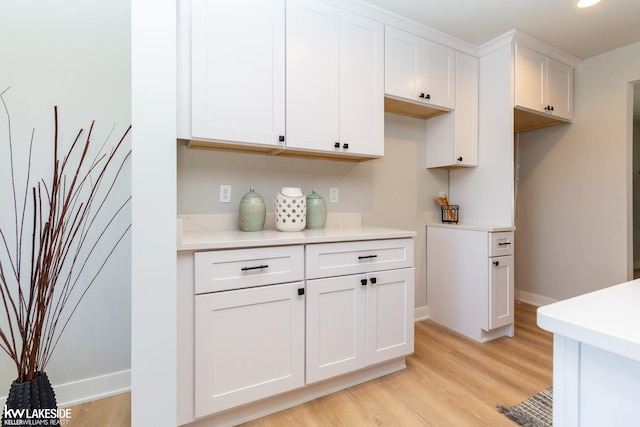 kitchen with white cabinetry and light wood-type flooring