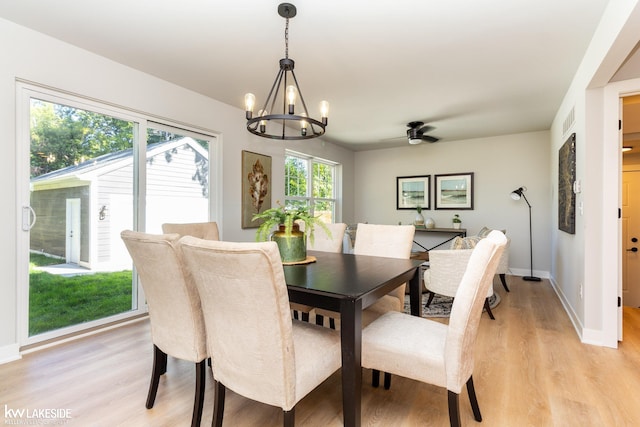 dining room featuring a notable chandelier and light hardwood / wood-style flooring