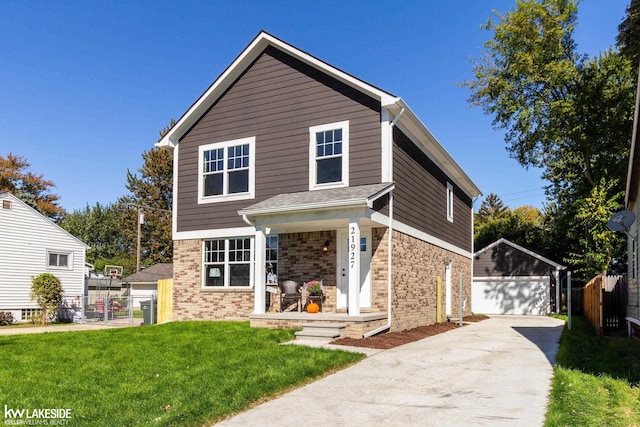 front of property featuring a garage, an outbuilding, and a front lawn