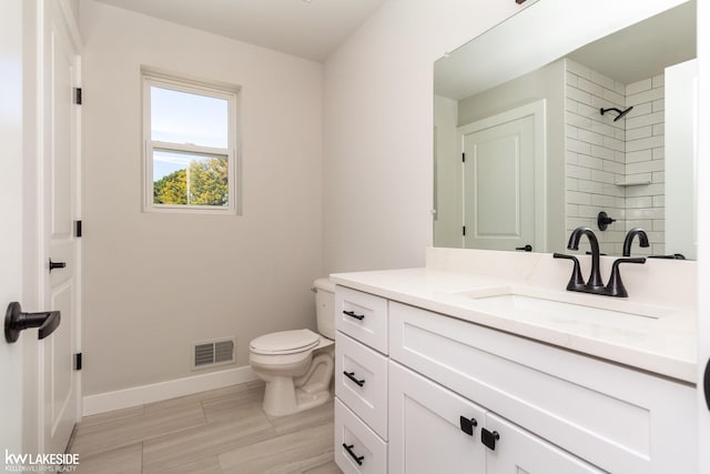 bathroom with vanity, wood-type flooring, and toilet