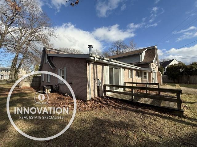 view of home's exterior featuring a wooden deck