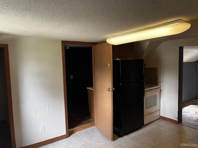 kitchen featuring black refrigerator and white electric range