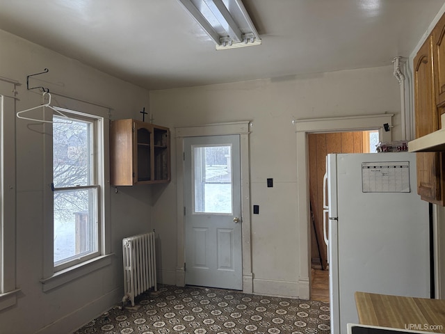 kitchen featuring white refrigerator and radiator heating unit