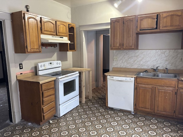 kitchen with tasteful backsplash, sink, and white appliances