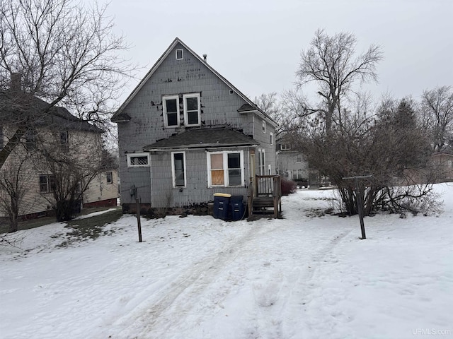 view of snow covered rear of property