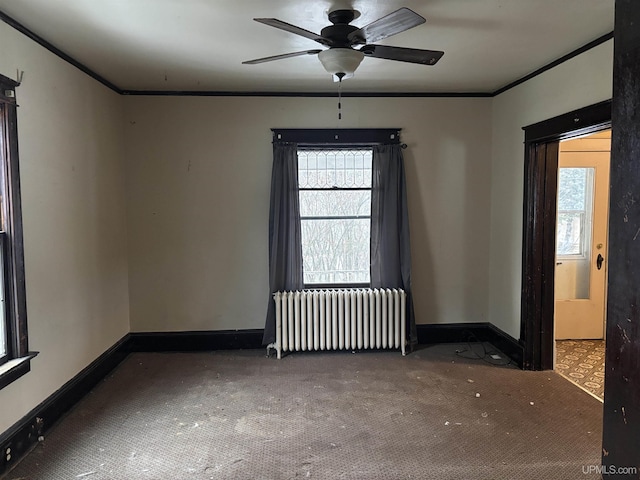 empty room featuring radiator heating unit, ceiling fan, and crown molding