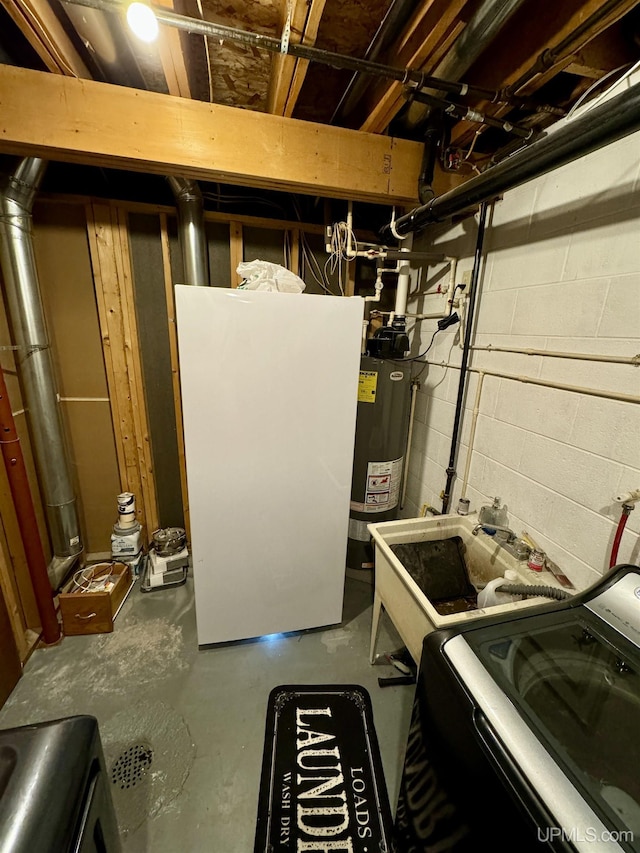 utilities featuring gas water heater and washer / clothes dryer