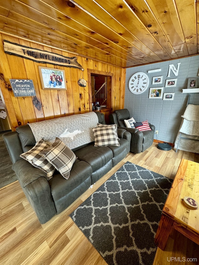 living room with hardwood / wood-style flooring, wood walls, and wood ceiling