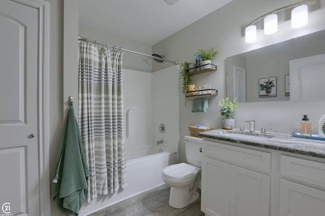 full bathroom with vanity, hardwood / wood-style flooring, toilet, and shower / bath combo with shower curtain