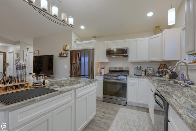 kitchen featuring white cabinets, sink, light stone countertops, light hardwood / wood-style floors, and stainless steel appliances