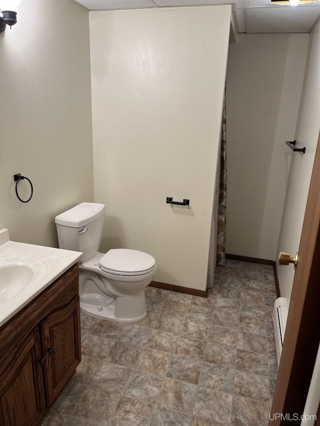 bathroom featuring vanity, a baseboard radiator, and toilet