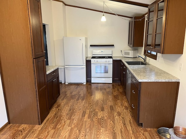 kitchen with dark hardwood / wood-style flooring, sink, hanging light fixtures, and white appliances