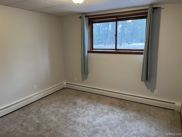 unfurnished room featuring carpet and a baseboard heating unit