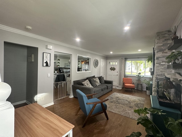 living room with dark hardwood / wood-style floors, a stone fireplace, and crown molding