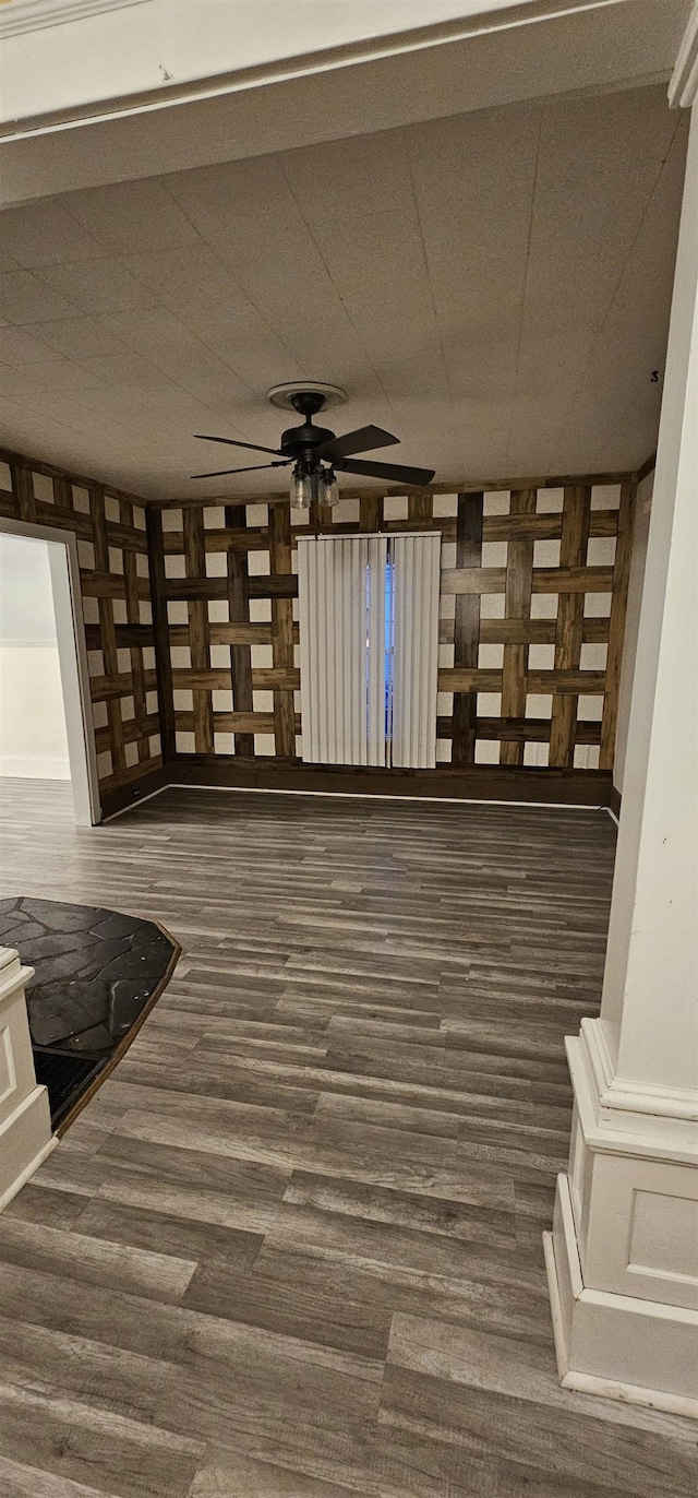 interior space with ceiling fan and dark wood-type flooring