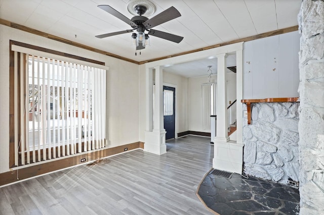 entrance foyer with decorative columns, ceiling fan, and hardwood / wood-style flooring