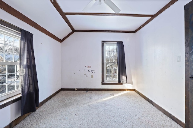 carpeted spare room with ceiling fan and lofted ceiling