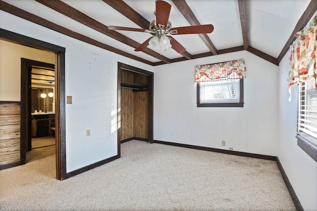 unfurnished bedroom featuring ceiling fan, carpet floors, and lofted ceiling with beams