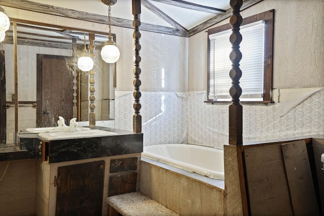 bathroom featuring vanity and tiled bath