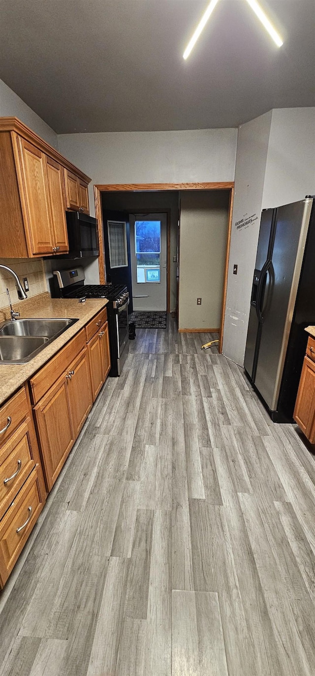 kitchen featuring sink, stainless steel appliances, and light hardwood / wood-style flooring