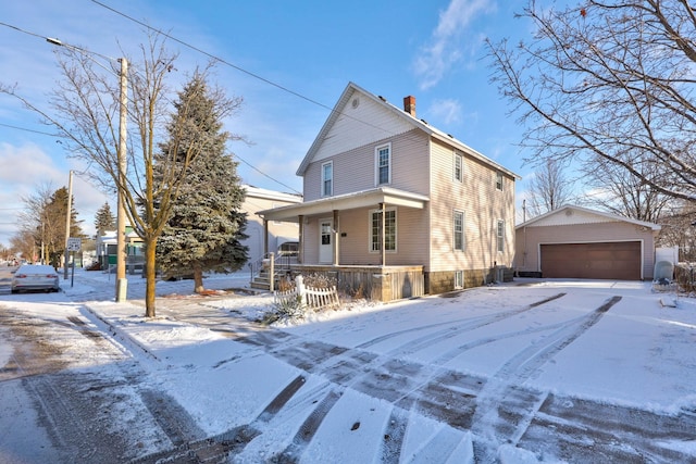 view of front of house with covered porch, a garage, and an outdoor structure