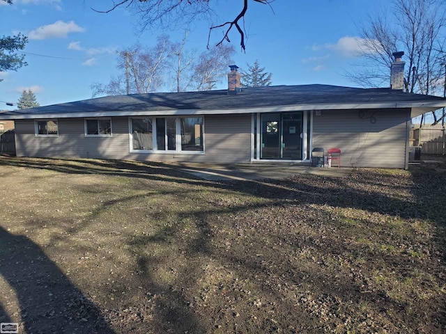 back of house featuring a yard and central AC unit